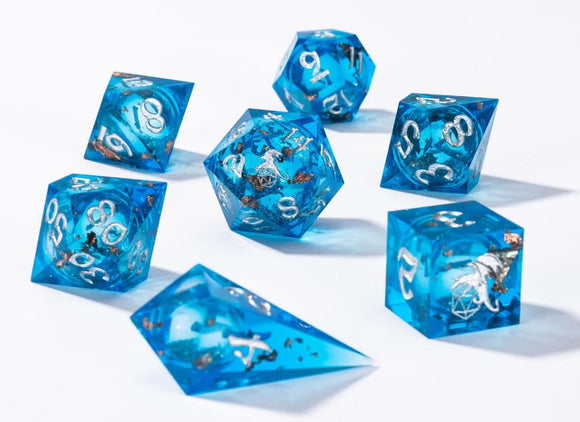 A vibrant set of blue liquid core sharp edge dice featuring intricate designs and metallic flakes inside. The seven polyhedral dice showcase numbers in a striking white font against the shimmering blue background, making them perfect for tabletop games. The sharp edges and glossy finish provide an appealing aesthetic, suitable for both collectors and gamers.