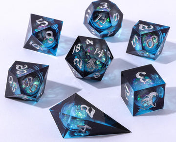 The Twilight Azure Liquid Core Sharp Edge Dice Set by Hymgho features a collection of seven beautifully crafted polyhedral dice. Each die is encased in a translucent dark azure material with shimmering aquatic hues and embedded glitter that creates a mesmerizing liquid core effect. Numbers are intricately engraved in silver, adding to the elegant design. Perfect for tabletop gaming enthusiasts looking to enhance their gaming experience.