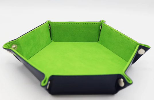 Grass green leatherette and velvet hex-shaped dice tray featuring a smooth exterior and soft interior. The tray is designed for storing and rolling dice, ideal for tabletop gaming enthusiasts.