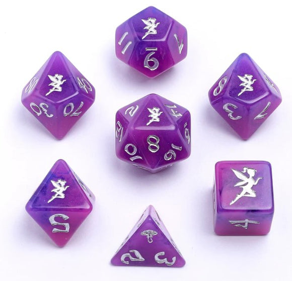 A colorful Pixie Dust RPG Dice Set by Hymgho, featuring seven polyhedral dice in shades of purple with silver numbers and intricate fairy designs. Perfect for tabletop gaming.