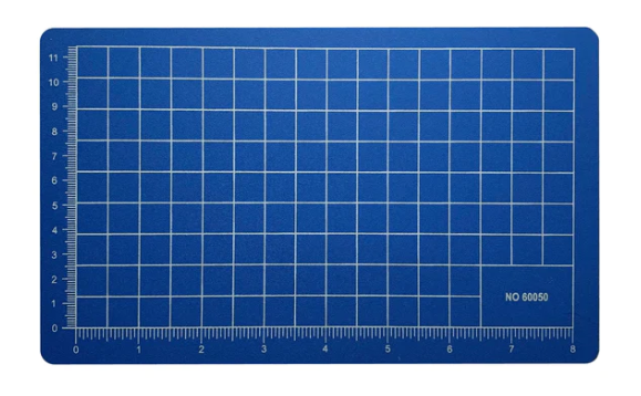 5.5" X 9" blue cutting mat designed for precise cutting and crafting. Features a grid pattern for accurate measurements, making it ideal for DIY projects and arts and crafts.