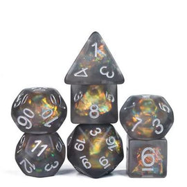 A set of Orichalcum Ore RPG dice featuring a unique blend of dark colors and shimmering effects. The set includes various shapes: a pyramid, a dodecahedron, and a cube, all with clear, white numerical markings for easy reading. Ideal for tabletop gaming enthusiasts.