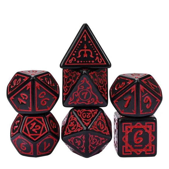 A set of Cryptic Knots Dried Blood dice featuring intricate red designs on a black background. The collection includes various shapes: a pyramid, a cube, and several polyhedral dice, perfect for tabletop gaming.