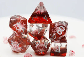 A set of stunning Ghost Spider RPG dice featuring various shapes and sizes, primarily in a translucent red color with intricate designs of white spiders embedded within. The numbers are engraved in silver for easy readability. The set includes polyhedral dice typically used in tabletop role-playing games.
