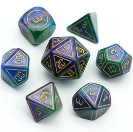 A set of Cybernated Purple and Green RPG dice featuring various shapes and numbers. The seven dice include a d20, d12, d10, d8, d6, d4, and a d3. The colors blend shades of purple and green with golden numbering.