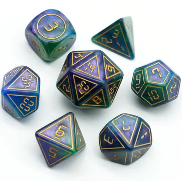 A set of Cybernated Purple and Green RPG dice featuring various shapes and numbers. The seven dice include a d20, d12, d10, d8, d6, d4, and a d3. The colors blend shades of purple and green with golden numbering.
