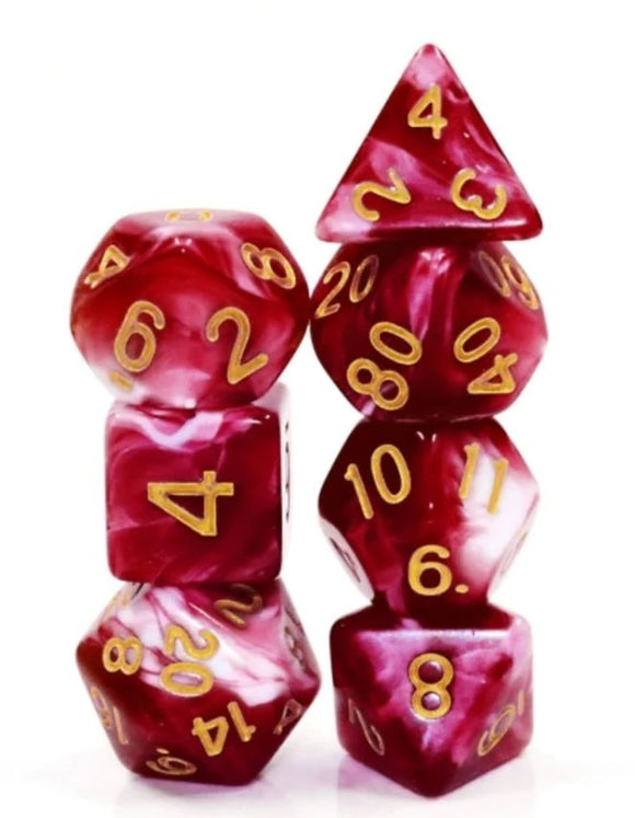 A close-up view of a Cherry Cream RPG Dice Set, featuring a variety of polyhedral dice in vibrant cherry red and white marbling with gold numbers. The set includes multiple shapes such as a D20, D12, D10, D8, D6, and D4, stacked artistically to showcase their design, ideal for tabletop gaming and role-playing adventures.