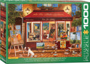 A beautiful jigsaw puzzle box featuring a Fine Art Gallery scene. The artwork displays an inviting gallery with a red awning, numerous paintings on the walls and easels, and a cheerful dog resting on the floor. The gallery showcases vibrant colors and intricate details, making it perfect for art lovers and puzzle enthusiasts. The box contains 1000 pieces for an engaging and creative experience.