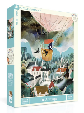 The On a Voyage jigsaw puzzle by New York Puzzle Company features a whimsical illustration of a hot air balloon soaring over a picturesque landscape. The colorful artwork displays a woman in the basket with flowing red hair, accompanied by birds, as it glides above charming houses and lush greenery, inviting puzzlers into a serene adventure.