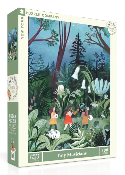 The Tiny Musicians jigsaw puzzle box features a vibrant illustration of children playing musical instruments in a lush, green forest. The artwork displays colorful flowers and trees under a night sky, creating a whimsical atmosphere. The puzzle contains 500 pieces and is made by New York Puzzle Company.
