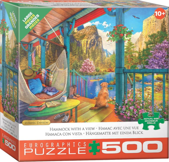 The 'Hammock with a View' jigsaw puzzle by EuroGraphics features a serene scene of a hammock on a porch, with a dog and a beautiful landscape of mountains, trees, and a lake. The puzzle box displays vibrant colors and intricate details, capturing a relaxing outdoor atmosphere perfect for puzzle enthusiasts.