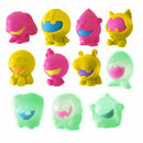 A colorful collection of 10 Nee Doh Dojee figures from Schylling. The figures are in various vibrant colors including pink, yellow, and green, featuring playful designs with smiling faces. Some figures glow in the dark, adding a fun twist to these fidget toys. Perfect for stress relief and sensory play.