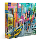 The Times Square 1000-piece jigsaw puzzle by eeboo features a vibrant and colorful depiction of New York City's iconic Times Square. The packaging showcases bustling streets filled with yellow taxis, lively pedestrians, and bright advertisements that capture the essence of this famous locale. Made with recycled materials, it emphasizes eco-friendliness while providing a fun and engaging experience for puzzle enthusiasts.