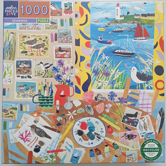 Colorful 1000-piece jigsaw puzzle featuring seabirds and coastal scenery. The puzzle design includes vibrant illustrations of birds, flowers, and marine life, set against a backdrop of a lighthouse and boats. The artwork showcases a mix of artistic elements, such as photographs and drawings, surrounded by various crafting supplies.