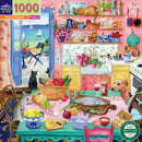 A vibrant and colorful illustration of a pink kitchen filled with various kitchenware, fruits, vegetables, and playful pets. A cozy scene showcases a dog sitting beside a table with a fish on a cutting board, a basket of tomatoes, and a bowl of lemons, while a curious cat lounges on a shelf above. The window reveals a scenic view of the sea and sailboats.
