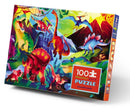 Dinosaur World Holographic Foil Jigsaw Puzzle by Crocodile Creek featuring a vibrant illustration of various dinosaurs in a lush landscape. The colorful box displays a mix of T-Rex, Triceratops, and Pterodactyls amidst mountains and trees, showcasing the fun and excitement of building the puzzle.