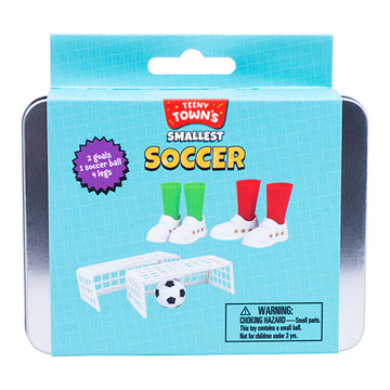 Teeny Tiny Soccer game by Fizz Creations Inc. features a compact metal tin containing 2 mini goals, 1 soccer ball, and 4 player legs dressed in green and red socks. A fun miniature soccer experience for kids.