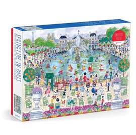 Michael Storrings' Springtime in Paris jigsaw puzzle by Galison features a vibrant illustration of a park scene in Paris. The 1000-piece puzzle showcases lush greenery, a fountain, and people enjoying various activities such as sailing model boats in the pond, walking, and sitting on benches, all under a clear blue sky with the Eiffel Tower in the background.