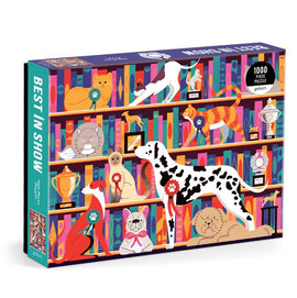 The 'Best in Show' jigsaw puzzle by Galison features a colorful illustration of various pets including a dalmatian, pug, cat, and more, set against a backdrop of trophies and bookshelves. The playful design showcases pets adorned with ribbons, celebrating their charm. The box contains 1000 pieces, perfect for puzzle enthusiasts and animal lovers alike.