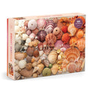 A vibrant 1000-piece jigsaw puzzle featuring an array of colorful seashells, including starfish and various shell patterns, beautifully arranged on the box cover by Galison.