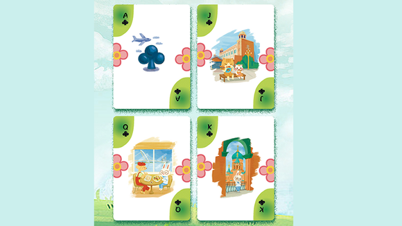 A set of playing cards from the 'Early Summer Trip' series by Murphy's Magic, featuring colorful illustrations. The cards display an airplane, a blue club symbol, and charming scenes of a quaint town with cute characters, including a setting with animals at a table. The design is vibrant and playful, ideal for summer-themed games.