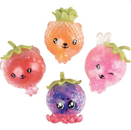 A set of four cute fruit squeeze beads in vibrant colors. The beads are shaped like various fruits, including a strawberry, a peach, and a purple berry. Each bead has a happy, playful expression with details like eyes and tiny leaves. The beads are translucent, showcasing a squishy texture, making them perfect for fidgeting or sensory play.