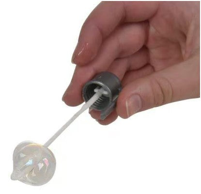 A hand holding a gray bubble wand with a round, translucent bubble on the end. The wand features a container that dispenses a bubble solution, ideal for children and outdoor play.