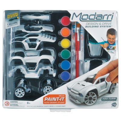 Deluxe Paint It Auto Design Studio by U.S. Toy featuring a creative DIY kit that includes a customizable car model, paint in various colors, and design tools. The packaging displays a child engaged in the design process, showcasing the fun and engaging nature of this product.