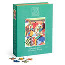 A vibrant jigsaw puzzle featuring the Imperial Hotel design by Frank Lloyd Wright. The packaging showcases bold, geometric patterns in various colors, with a stylish teal background. Several colorful puzzle pieces are scattered in front of the box, highlighting the 500-piece count. Perfect for architecture enthusiasts and puzzle lovers.