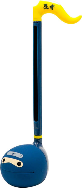 The Otamatone Ninja by Hamee features a fun, playful design. It has a blue body shaped like a ninja with a yellow, curved handle and expressive facial features. The musical instrument is designed for creative sound exploration, suitable for kids and adults alike.