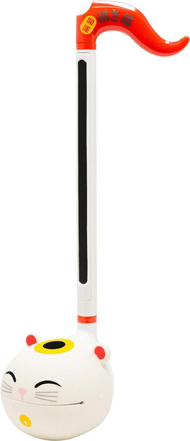 The Otamatone Lucky Cat by Hamee is a whimsical electronic musical instrument shaped like a smiling cat. Its body is white with a playful design, featuring a black stripe running down the neck and a red flag at the top. It offers a unique sound and interactive play, making it a fun addition to any toy collection.