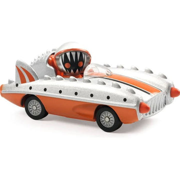 Crazy Motors: Piranha Kart by DJECO features a vibrant, cartoonish car designed like a shark, complete with spikes and an oversized, toothy grin. The car is orange with silver accents, showcasing fun details that appeal to children. Perfect for imaginative play and excitement.