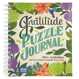 The Gratitude Puzzle Journal by Cottage Door Press features a beautifully illustrated cover with vibrant floral designs. The title 'Gratitude Puzzle Journal' is prominently displayed in bold, cheerful lettering. This interactive journal includes 365+ activities aimed at cultivating gratitude on a daily basis, making it a delightful and engaging tool for self-reflection and positivity.