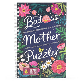A colorful and playful cover of the 'Bad*ss Mother Puzzler' book. It features vibrant flowers and the title in whimsical white lettering against a dark blue background, indicating that it includes coloring, crosswords, and curse words for a sassy, classy audience.