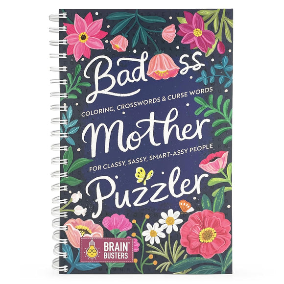 A colorful and playful cover of the 'Bad*ss Mother Puzzler' book. It features vibrant flowers and the title in whimsical white lettering against a dark blue background, indicating that it includes coloring, crosswords, and curse words for a sassy, classy audience.