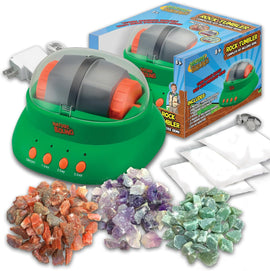 A vibrant green rock tumbler machine with a transparent lid, surrounded by various colorful gemstones in different sizes. The kit includes the tumbler itself, polishing powder, bags, and an AC adapter, all presented in a playful box designed for kids aged 8 and up.