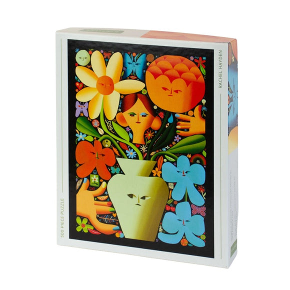 Self Portrait as a Florist jigsaw puzzle created by Kinstler. The box artwork features stylized flowers, colorful faces, and vibrant patterns, ideal for art lovers and puzzle enthusiasts.
