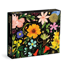 The Intergalactic Flora jigsaw puzzle by Galison features a vibrant design of various flowers against a black backdrop filled with stars and cosmic elements. The puzzle contains 1000 pieces and showcases colorful blooms in shades of pink, yellow, blue, and green, highlighting the intricate details of each flower. Ideal for puzzle enthusiasts and floral lovers alike.