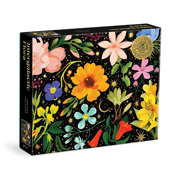 The Intergalactic Flora jigsaw puzzle by Galison features a vibrant design of various flowers against a black backdrop filled with stars and cosmic elements. The puzzle contains 1000 pieces and showcases colorful blooms in shades of pink, yellow, blue, and green, highlighting the intricate details of each flower. Ideal for puzzle enthusiasts and floral lovers alike.
