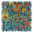 A vibrant jigsaw puzzle titled 'Day Dreaming' featuring an intricate design of colorful flowers, birds, and foliage against a blue background. The puzzle pieces have a unique scalloped edge, enhancing the artistic presentation of this whimsical nature scene.