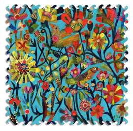 A vibrant jigsaw puzzle titled 'Day Dreaming' featuring an intricate design of colorful flowers, birds, and foliage against a blue background. The puzzle pieces have a unique scalloped edge, enhancing the artistic presentation of this whimsical nature scene.
