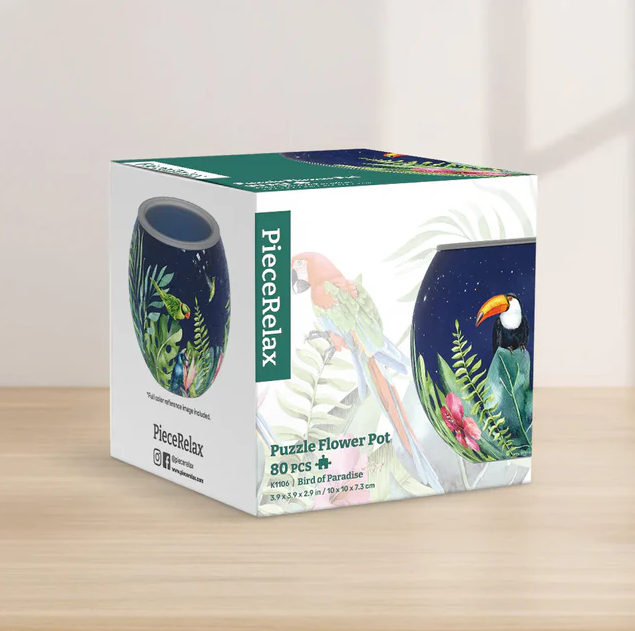 A jigsaw puzzle box titled 'Bird of Paradise' by Pintoo Corporation. The box features vibrant illustrations of tropical birds and plants on its sides, showcasing a colorful design perfect for puzzle enthusiasts. The dimensions listed are 10 x 10 x 7.3 cm, and it contains 80 puzzle pieces.