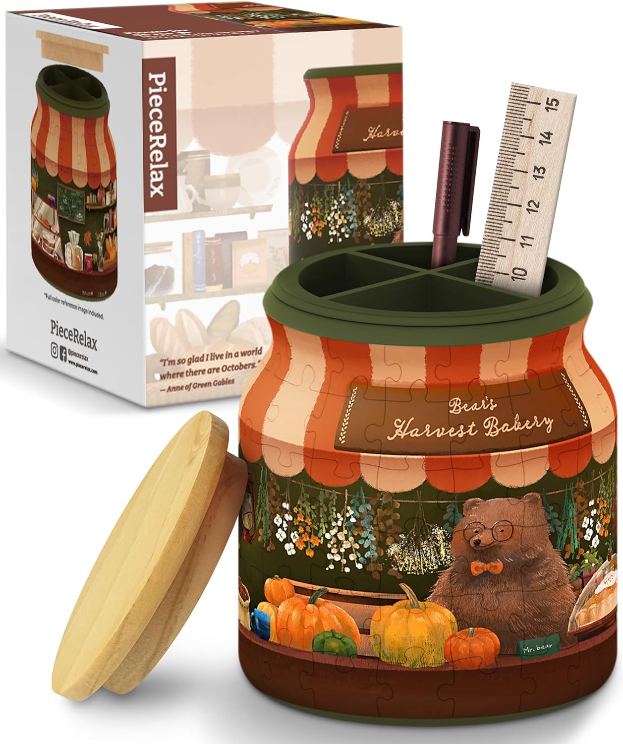 A jigsaw puzzle designed as a charming jar, titled 'Bear's Harvest Bakery.' The jar features a bear character in glasses and a bow tie, surrounded by pumpkins and flowers, promoting a cozy autumn bakery theme. The jar lid is wooden, complementing the colorful artwork. The packaging showcases the jigsaw's visual appeal and includes writing that says 'PieceRelax.'