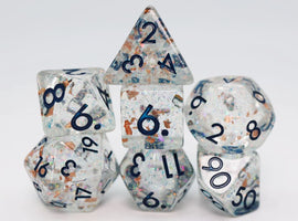 A beautiful Frozen in Time RPG Dice Set featuring six polyhedral dice made from transparent material with shimmering flakes. The numbers are printed in bold black, making them easy to read. The set includes a d20, d12, d10, d8, d6, and d4, perfect for tabletop role-playing games.