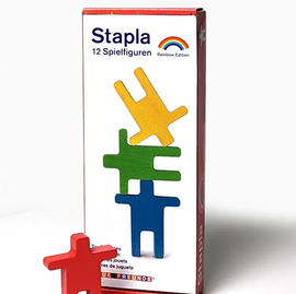 Stapla-Balancing Figures Color by Neue Freunde. This colorful set features 12 wooden figures in vibrant colors, including red, yellow, green, and blue, packaged in an eye-catching box. Ideal for creative play, stacking challenges, and enhancing fine motor skills.