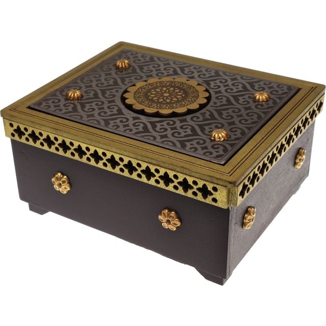 The Klick Box by Jean Claude is an intricately designed mechanical puzzle box featuring a rich black surface accented by gold embellishments. The lid boasts a beautiful mandala design, while the sides showcase delicate cutouts and ornamental motifs, making it an elegant piece for puzzle enthusiasts.