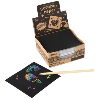 U.S. Toy Scraper Paper set featuring a box containing 125 sheets of black scraper paper. Included is a wooden scraper tool. A sample paper shows colorful designs with a rainbow and an ice cream cone drawn on it, demonstrating the capabilities of the scraper paper for creating vibrant artwork.