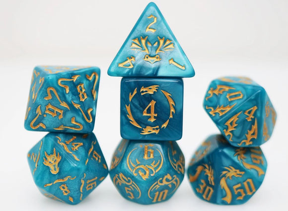 Colorful set of polyhedral RPG dice in cobalt blue with intricate gold designs. The set includes a D20, D12, D10, D8, D6, and D4, perfect for tabletop gaming.
