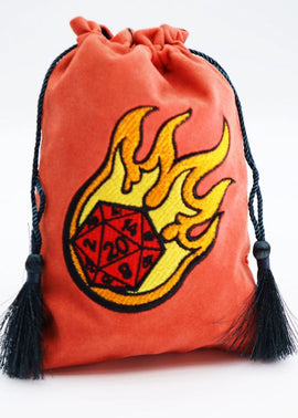 A vibrant orange dice bag featuring a fiery design with a twenty-sided die (D20) partially covered by flames, complete with black tassels for closure. Ideal for tabletop gaming enthusiasts and collectors.