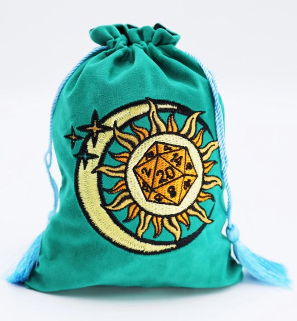 A plush, teal dice bag featuring an intricate embroidery design of a sun and moon, decorated with stars and a D20 dice emblem. The bag has a drawstring closure and tassels.